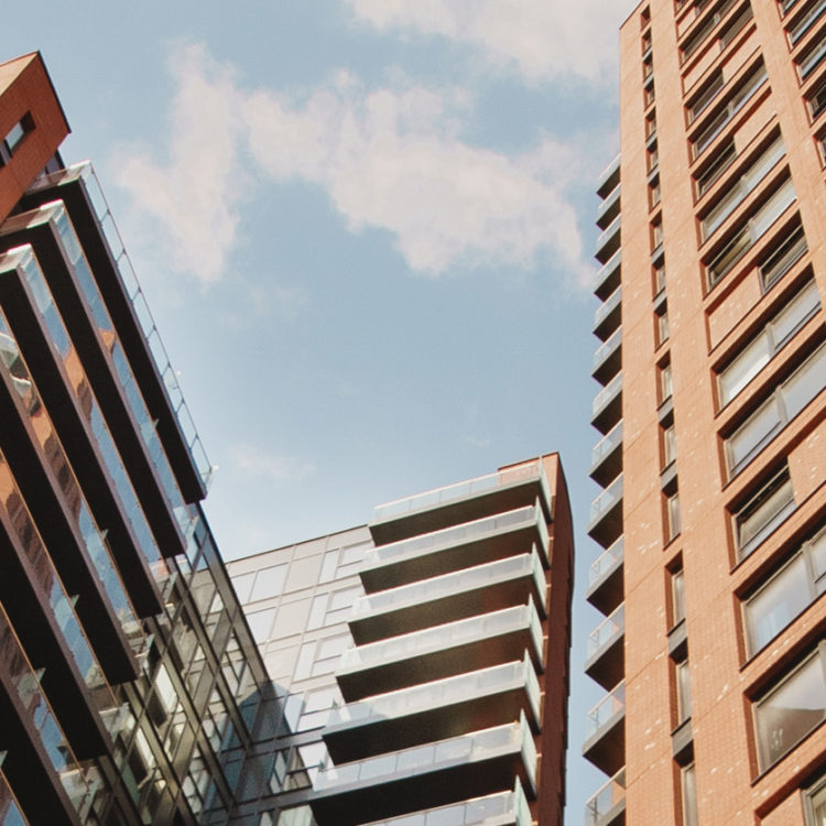 Looking up at the Orchard Wharf apartment blocks in Docklands, London