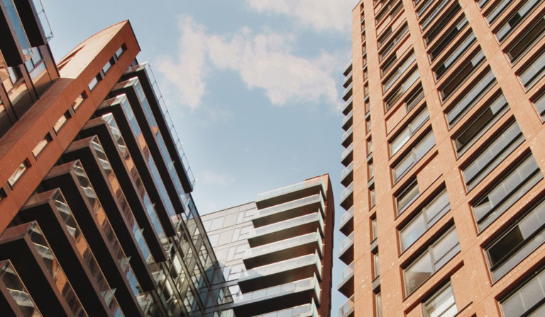 Looking up at the Orchard Wharf apartment blocks in Docklands, London