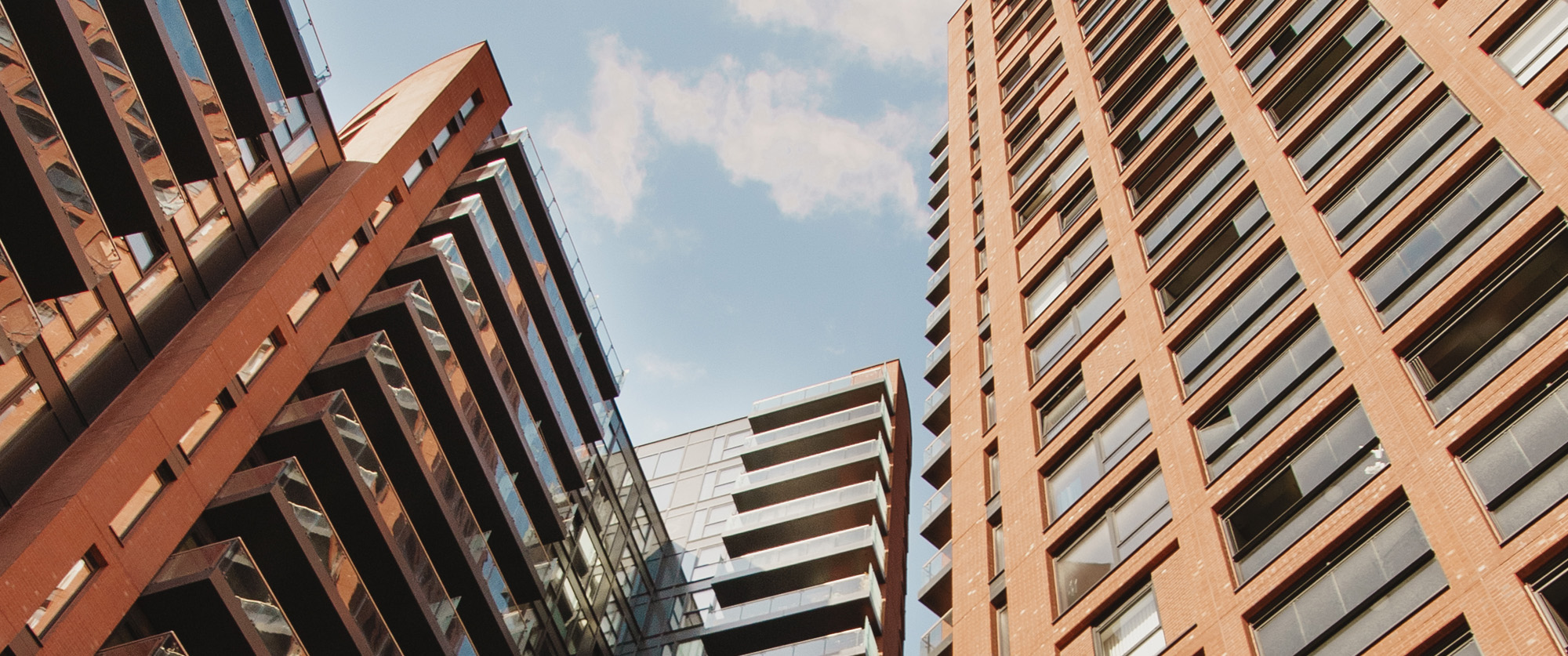 Looking up at the Orchard Wharf apartment blocks in Docklands, London